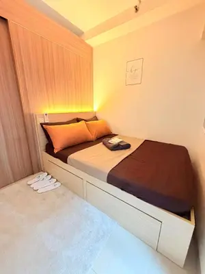 a small bedroom with a bed in a room at Bayshore Getaway Condotel by Clowie in Manila