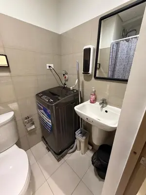 a small bathroom with a toilet and a sink at Bayshore Getaway Condotel by Clowie in Manila