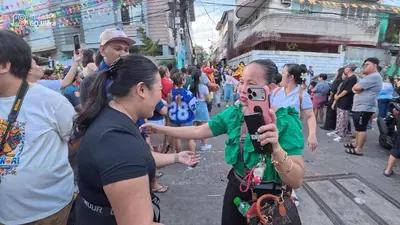 a woman taking a picture of a crowd of people at Bayshore Getaway Condotel by Clowie in Manila