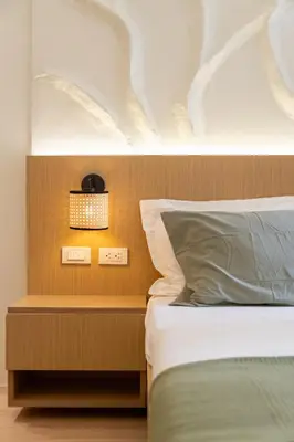 a bedroom with a bed with a wooden head board at Luxury 1 BR City View in Park Mckinley West Fast Wi-Fi Washer Dryer in Manila