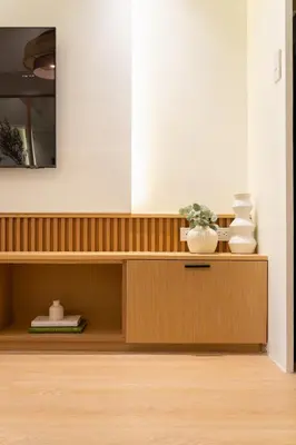 a wooden cabinet with vases on it in a room at Luxury 1 BR City View in Park Mckinley West Fast Wi-Fi Washer Dryer in Manila