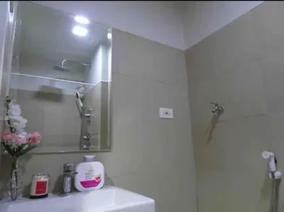 a bathroom with a sink and a shower with a mirror at Casa Laelia in Manila