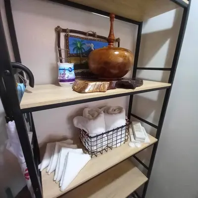 a shelf with towels and a pot on it at The Morgan Residences in Manila