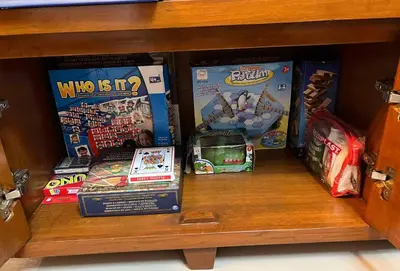 a shelf with many games and toys on it at The Morgan Residences in Manila