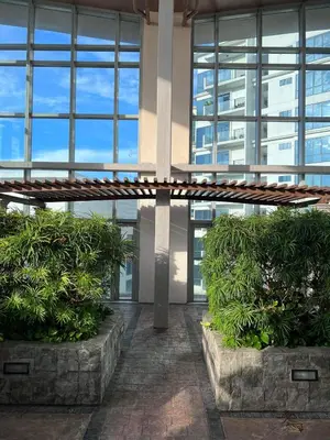 a building with two large bushes in front at The Morgan Residences in Manila