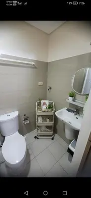a bathroom with a white toilet and a sink at Classy Stay in Manila
