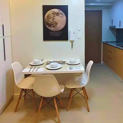 a dining room with a table and chairs and the moon on the wall at Shore 2 Residences Entire Condo in Pasay City Near SM Mall of Asia in Manila