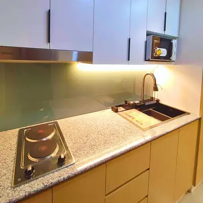 a kitchen counter with a sink and a stove at Shore 2 Residences Entire Condo in Pasay City Near SM Mall of Asia in Manila
