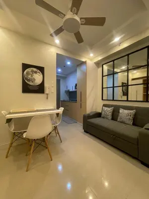 a living room with a couch and a ceiling fan at Shore 2 Residences Entire Condo in Pasay City Near SM Mall of Asia in Manila