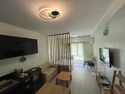 a living room with a couch and a table at Ports Den in Manila