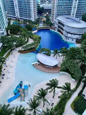 a large pool at a resort with a slide at SYM staycation at Azure in Manila