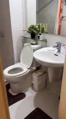 a bathroom with a toilet and a sink at SYM staycation at Azure in Manila