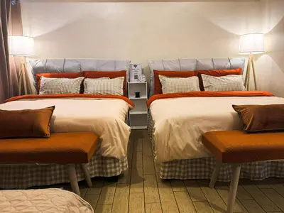 two beds in a room with orange pillows at Staycation in Manhattan near Smart Araneta in Manila