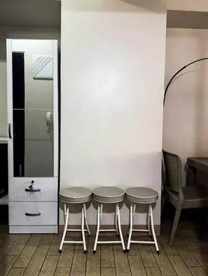 a table and two chairs in a room at Staycation in Manhattan near Smart Araneta in Manila