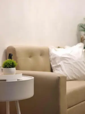 a couch and a table with a potted plant on it at 1569 Shore Residences MOA in Manila