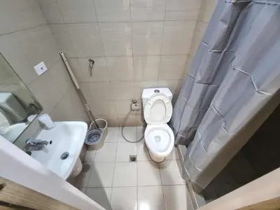 a small bathroom with a toilet and a sink at 1569 Shore Residences MOA in Manila