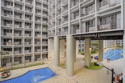 an apartment building with a swimming pool in the courtyard at Relaxing 1BR Balcony with Pool View Plus Free Parking in Manila