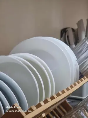 a stack of white plates sitting on a shelf at 1586 Shore Residences tower C2 in Manila