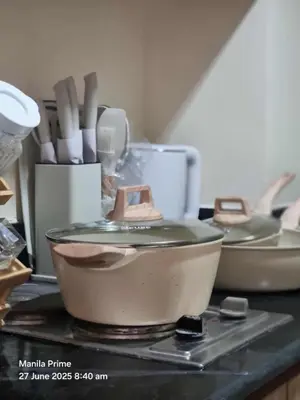 a kitchen counter with three pots and pans on it at 1586 Shore Residences tower C2 in Manila