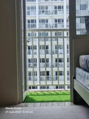 a view of a large building from a window at 1586 Shore Residences tower C2 in Manila