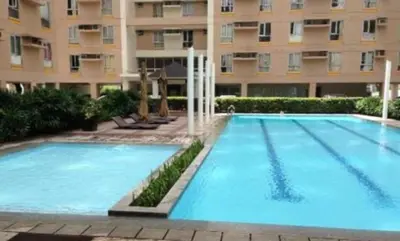 a large swimming pool in front of a building at Ports crib in Manila