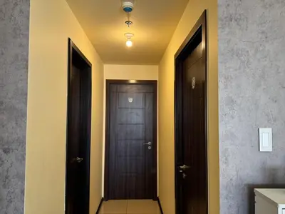 a hallway with two doors at The Grand Lower Penthouse 2 Bedrooms, 3 Baths in Manila