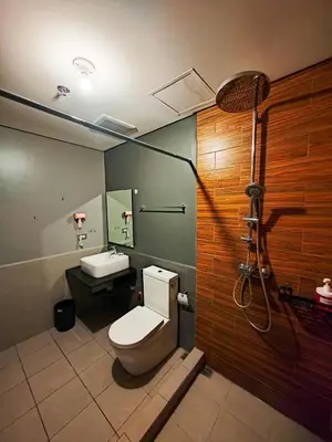 a bathroom with a toilet and a sink at The Grand Lower Penthouse 2 Bedrooms, 3 Baths in Manila