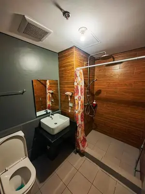 a bathroom with a white toilet and a sink at The Grand Lower Penthouse 2 Bedrooms, 3 Baths in Manila