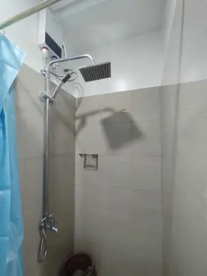 a shower stall in a bathroom with a toilet at SHORe 2 TOWER 3 UNIT 746 in Manila