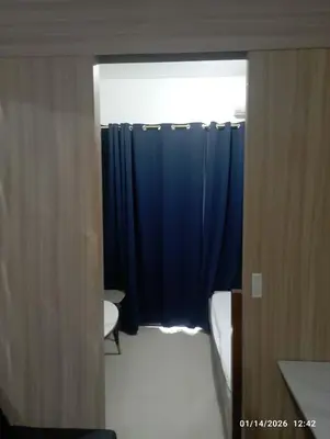 a bathroom with a blue shower curtain and a toilet at SHORe 2 TOWER 3 UNIT 746 in Manila