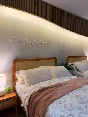 a bedroom with a bed with a sign on the wall at Twin Bed 1BR w Balcony with WiFi Netflix at Shore2 T1 near MOA and NAIA Airport in Manila