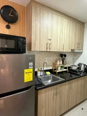 a kitchen with a stainless steel refrigerator and a sink at Twin Bed 1BR w Balcony with WiFi Netflix at Shore2 T1 near MOA and NAIA Airport in Manila