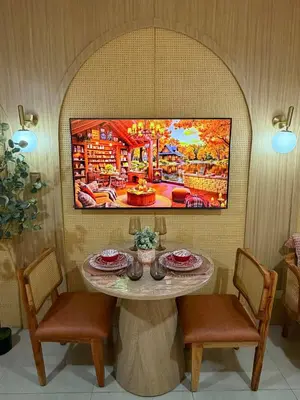 a tv hanging on a wall above a table at Twin Bed 1BR w Balcony with WiFi Netflix at Shore2 T1 near MOA and NAIA Airport in Manila
