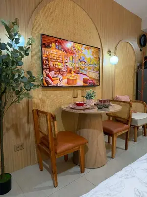 a room with a table with chairs and a painting on the wall at Twin Bed 1BR w Balcony with WiFi Netflix at Shore2 T1 near MOA and NAIA Airport in Manila