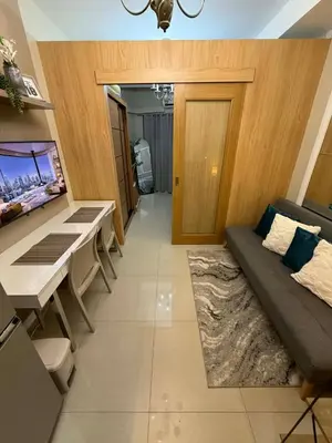 a living room with a couch and a table at Neo-Classic 1BR with WiFi Netflix at Shell Res near MOA and NAIA Airport in Manila