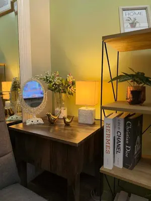 a desk with a mirror and a table with flowers on it at Neo-Classic 1BR with WiFi Netflix at Shell Res near MOA and NAIA Airport in Manila
