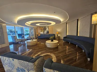 a living room with couches and tables in a building at Neo-Classic 1BR with WiFi Netflix at Shell Res near MOA and NAIA Airport in Manila