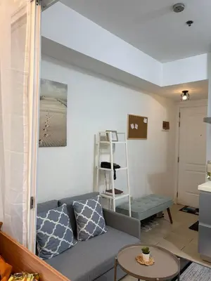 a living room with a couch and a table at Anasa Suites in Manila