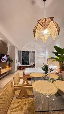 a room with a bed and a table and chairs at Cozy Stay 3 min to Rockwell City View Pool Parking in Manila