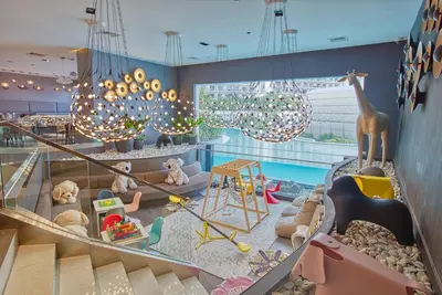 a childrens play area with toys and a pool at Cozy Stay 3 min to Rockwell City View Pool Parking in Manila