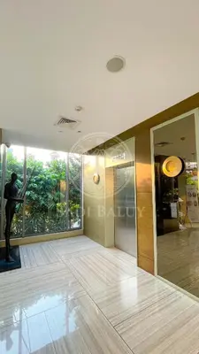 a room with a statue of a man in a building at Cozy Stay 3 min to Rockwell City View Pool Parking in Manila