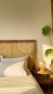 a bedroom with a bed and a table with a plant at Cozy Stay 3 min to Rockwell City View Pool Parking in Manila