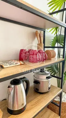 a shelf with a coffee maker and a tea kettle at Cozy Stay 3 min to Rockwell City View Pool Parking in Manila