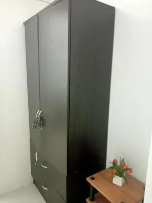 a black door in a room with a wooden table at Sea Residences Tower EF Rose in Manila