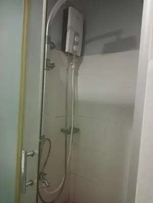 a shower with a glass door in a bathroom at Sea Residences Tower EF Rose in Manila