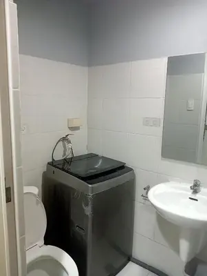 a bathroom with a toilet and a sink at Sea Residences Tower EF Rose in Manila