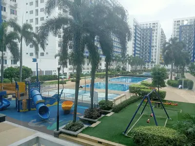 a view of a playground with a slide and a pool at Sea Residences Tower EF Rose in Manila