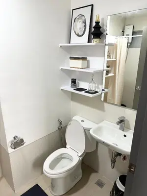 a bathroom with a toilet and a sink at Cozy Nature-Inspired Studio Unit in Cubao in Manila