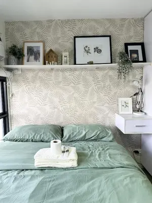 a bedroom with a bed with a towel on it at Cozy Nature-Inspired Studio Unit in Cubao in Manila