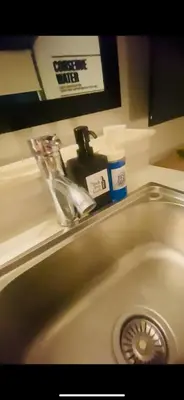 a bathroom sink with a faucet on top of it at Azure Haven in Manila